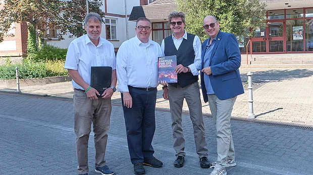Vertreter von SWG und der Bürgermeister von Pohlheim posieren vor dem Rathaus