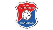 Logo mit einem rot-blauen Schild mit weißem Rand. Darin befindet sich ein weißer Fußball. Im roten oberen Teil steht „TV 05-07 HÜTTENBERG“ und im blauen unteren Teil steht „HANDBALL“ in weißer Schrift.