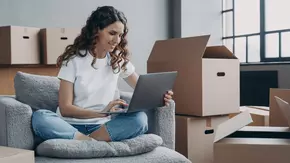 Happy young woman selling or purchasing apartment online. Investment and internet banking.