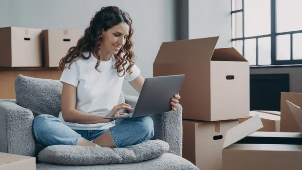 Happy young woman selling or purchasing apartment online. Investment and internet banking.