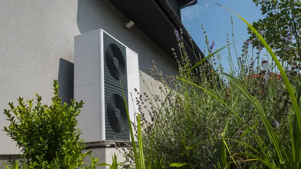 External heat pump unit against the wall of the house. Modern technologies for energy saving