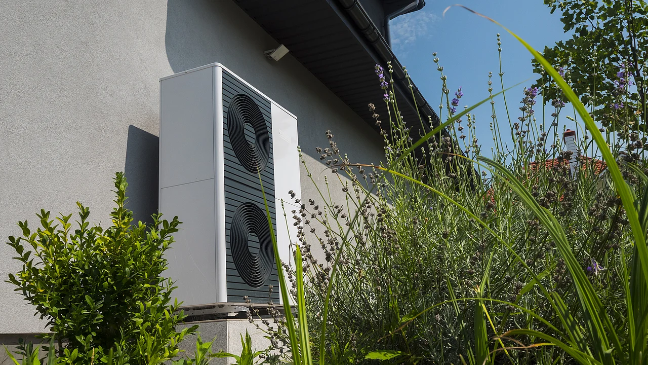 External heat pump unit against the wall of the house. Modern technologies for energy saving