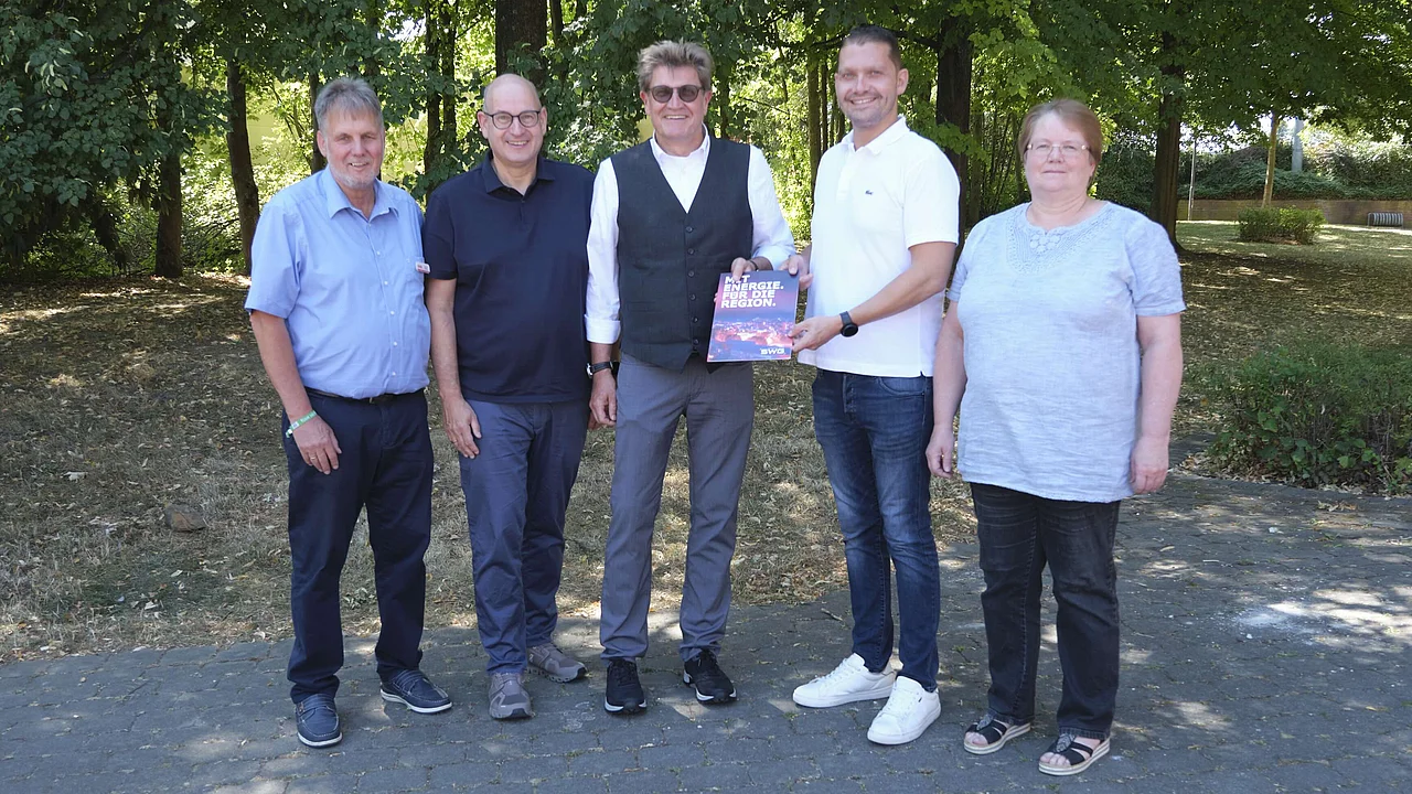 The photograph shows representatives from the town of Linden and SWG.